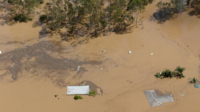 A house is completely submerged by flood waters west of Brisbane. Picture: AAP Image/Dave Hunt