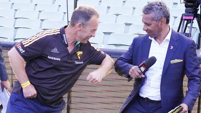 Clarko knocks elbows with former Brisbane Lion and TV commentator Gilbert McAdam. Picture: AAP