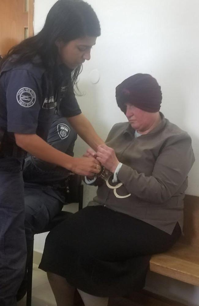 Malka Leifer is secured by a female police officer before her appearance in an Israeli court earlier this week.