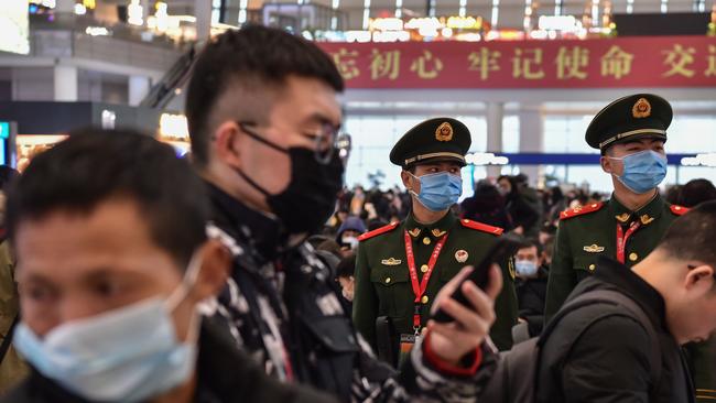 Masked paramilitary police stand guard at Hongqioa train station in China. Picture: AFP