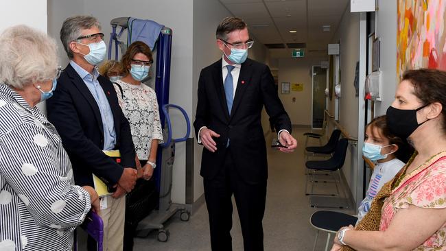 NSW Premier Dominic Perrottet speaks to the Panagopailos family as they await their children’s vaccination at the Sydney Children’s Hospital in Randwick on Monday, January 10. Picture: AAP Image/Bianca De Marchi