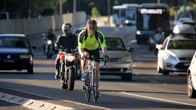 A bike rider without a helmet riding amongst traffic on Alison Rd at Randwick. Picture: John Grainger