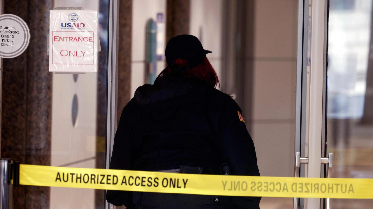 A security guard stands at the entrance to the U.S. Agency for International Development (USAID) headquarters on February 03, 2025 in Washington, DC. (Photo by Kevin Dietsch / GETTY IMAGES NORTH AMERICA / Getty Images via AFP)