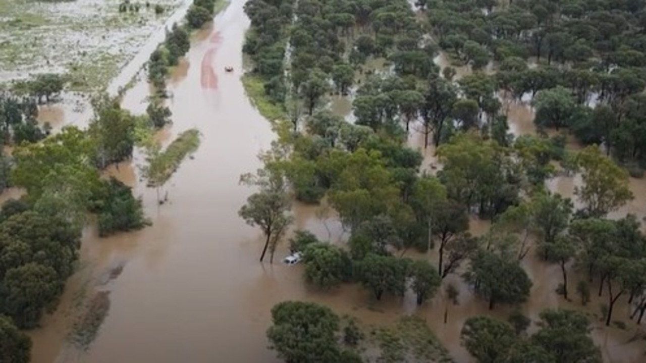 Swift water rescue crews rescued a driver stranded on his ute's roof after his vehicle was swept of the roadway at Balyendo crossing. Image: QFD