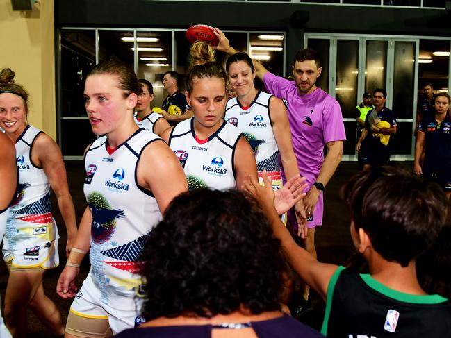 Adelaide Crows' Danielle Ponter, centre, hands out high fives to family members as she takes to the field in front of a home crowd during the AFLW trial match against the Fremantle Dockers in Darwin. Picture: Justin Kennedy