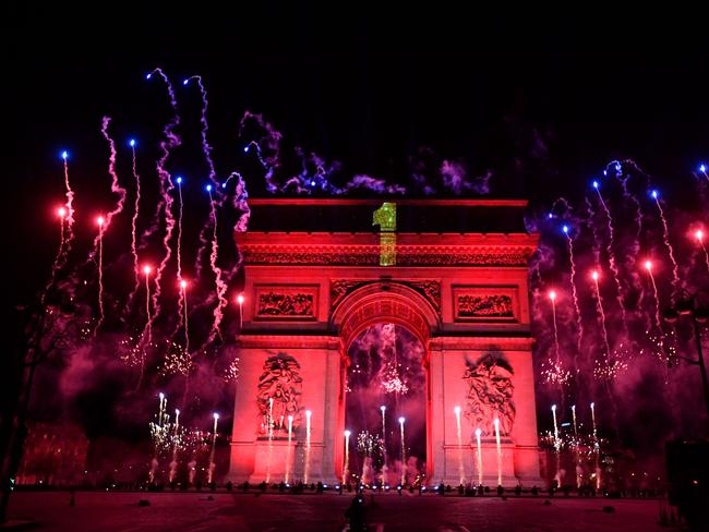 Fireworks explode next to the Arc de Triomphe as the clock strikes midnight. Picture: AFP