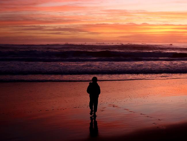 CURRUMBIN, AUSTRALIA - APRIL 25:  A young girl watches the burial at sea during the ANZAC dawn service on April 25, 2024 in Currumbin, Australia. Anzac Day is a national holiday in Australia, traditionally marked by a dawn service held during the time of the original Gallipoli landing and commemorated with ceremonies and parades throughout the day. Anzac Day commemorates the day the Australian and New Zealand Army Corp (ANZAC) landed on the shores of Gallipoli on April 25, 1915, during World War 1. (Photo by Chris Hyde/Getty Images)