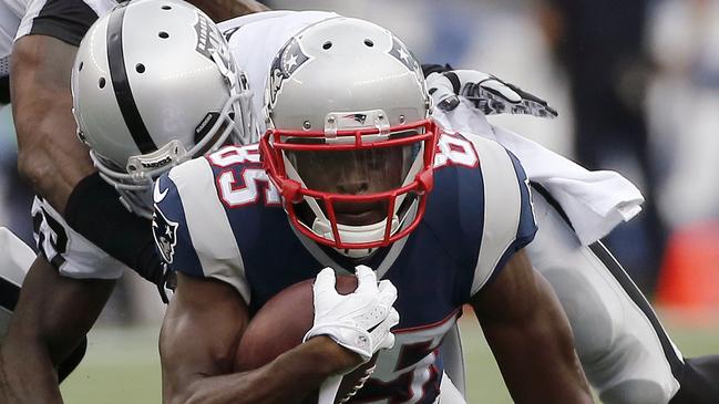 Oakland Raiders cornerback Tarell Brown, rear, tackles New England Patriots wide receiver Kenbrell Thompkins (85) after a catch in the second half of an NFL football game Sunday, Sept. 21, 2014, in Foxborough, Mass. (AP Photo/Elise Amendola)