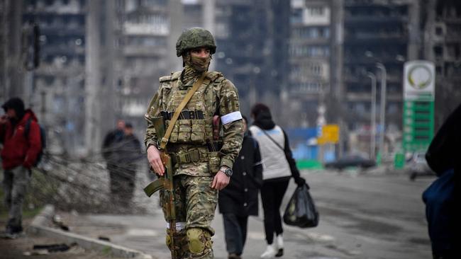 A Russian soldier patrols in a street of Mariupol. A series of setbacks on the battlefield, massive military casualties and a wildly unpopular draft mean that just one in four Russians is now in favour of continuing the war in Ukraine. Picture: AFP