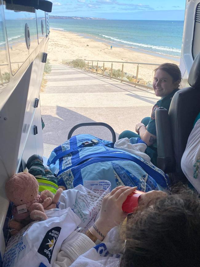 Lily Thai and Danika Pederzolli in the back of an ambulance, enjoying McDonald's at the beach. Picture: Danika Pederzolli