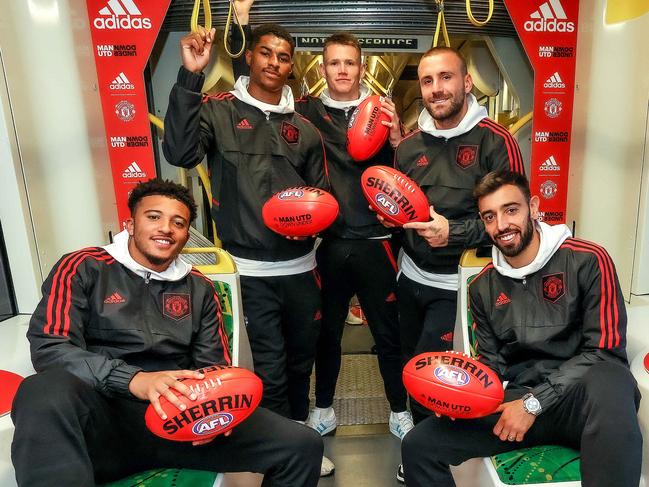 Manchester United players Jadon Sancho , Marcus Rashford , Scott McTominay , Luke Shaw and Bruno Fernandez board a tram in Melbourne before heading to greet fans at Federation Square. Picture: Ian Currie