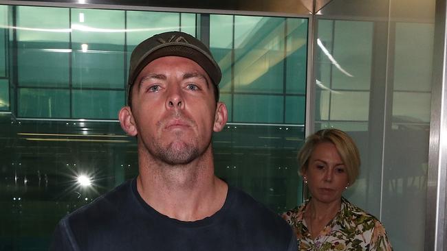 Constable Zach Rolfe arriving at Canberra Airport, accompanied by his mother Deb, after being charged with murder.