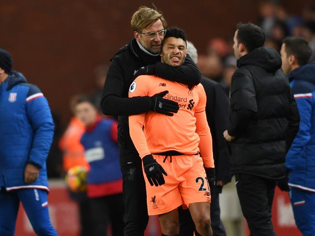 Jurgen Klopp holds back Alex Oxlade-Chamberlain. (Photo by Gareth Copley/Getty Images)