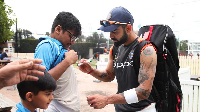 India captain Virat Kohli signs an autographs at the SCG yesterday. Picture: Phil Hillyard