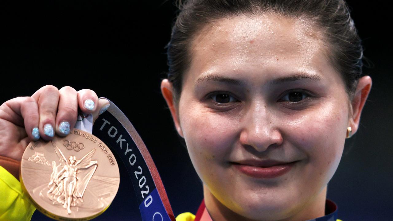 Melissa Wu proudly shows off her bronze medal.