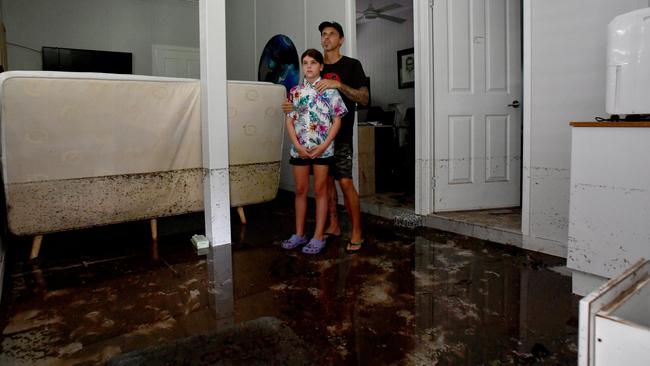 Tuesday February 4. Heavy rain causes flooding in North Queensland. Bluewater residents Anthony Waugh, with daughter Nyah, 9, at the ground floor of their Forrestry Road home inundated by a fast rising Bluewater Creek. Picture: Evan Morgan