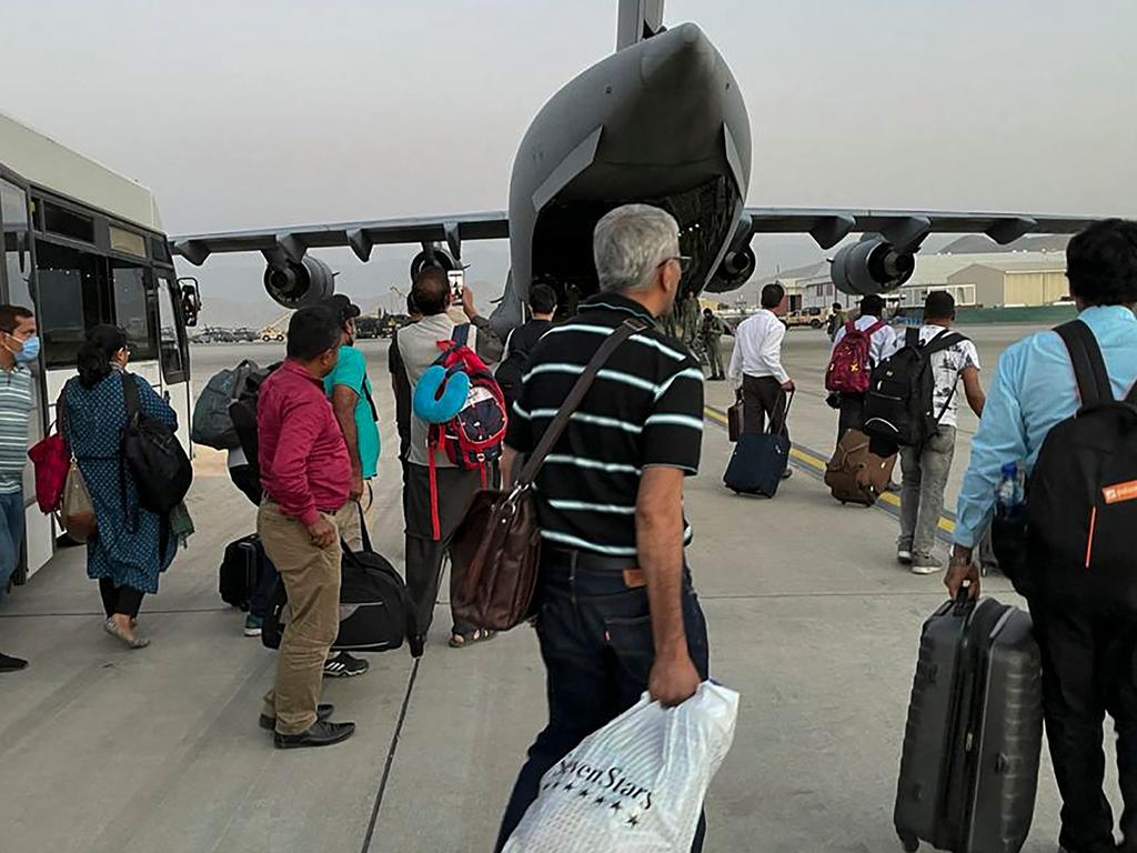 Indian Nationals prepare to board an Indian military aircraft at the airport in Kabul on August 17. Picture: AFP