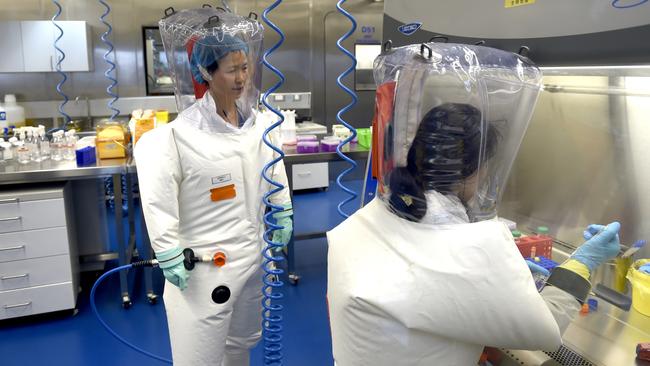 Virologist Shi Zheng-li, left, works with her colleague in the P4 lab of Wuhan Institute of Virology (WIV) in Wuhan in central China's Hubei province, in 2017. Picture: Getty