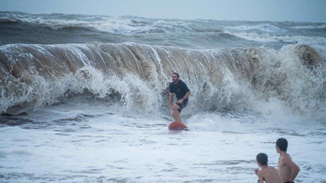 Top End Monsoon, 2024. Surfing at the Nightcliff Beach, Darwin. Picture: Pema Tamang Pakhrin