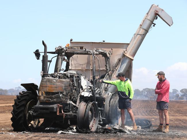 Brothers Jack and Tom Giles survey the damage to their farm machinery destroyed by fire near Edithburgh. Picture: Tait Schmaal