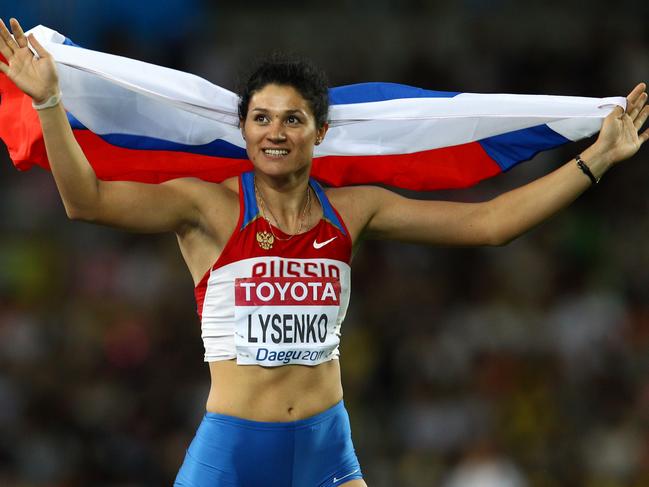 Tatyana Lysenko of Russia celebrates with her country's flag after claiming gold in the women's hammer throw final during day nine of the 13th IAAF World Athletics Championships in South Korea. Picture: Getty Images