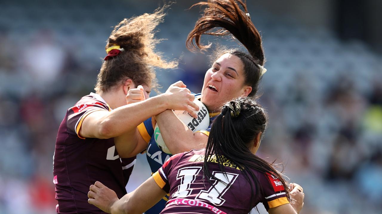 Rima Butler collides with two Broncos. Picture: Brendon Thorne/Getty