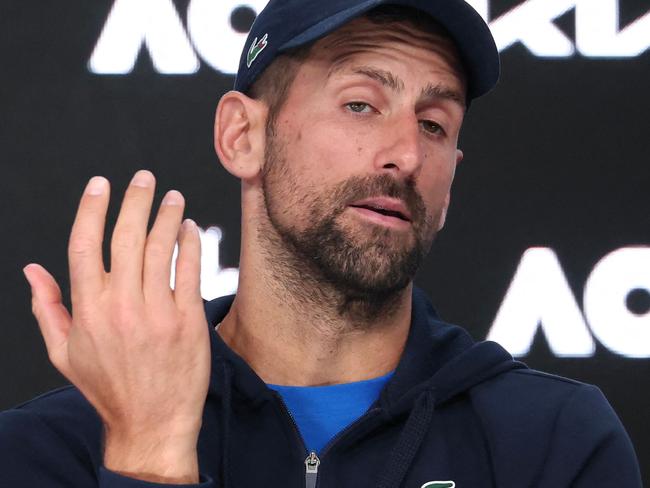 TOPSHOT - Serbia's Novak Djokovic speaks during a press conference after retiring from his men's singles semi-final match against Germany's Alexander Zverev on day thirteen of the Australian Open tennis tournament in Melbourne on January 24, 2025. (Photo by DAVID GRAY / AFP) / -- IMAGE RESTRICTED TO EDITORIAL USE - STRICTLY NO COMMERCIAL USE --