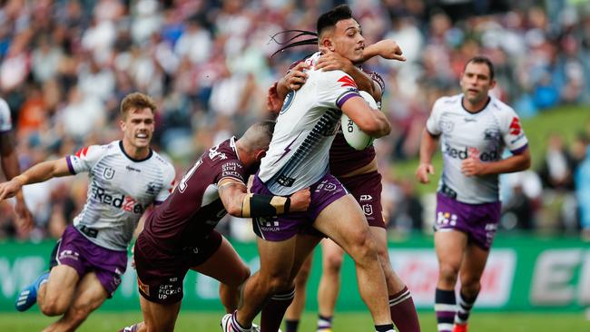 Tino Fa'asuamaleaui of the Storm is tackled by the Sea Eagles defence during the Round One NRL match between Manly Sea Eagles and Melbourne Storm at Brookvale Oval in Sydney, Sunday, March 15, 2020. (AAP Image/Brendon Thorne)