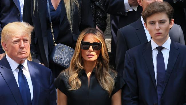 NEW YORK, NEW YORK - JULY 20: former U.S. President Donald Trump and his wife Melania Trump along with their son Barron Trump and Ivanka Trump, Eric Trump and Donald Trump Jr. and their children watch as the casket of Ivana Trump is put in a hearse outside of St. Vincent Ferrer Roman Catholic Church during her funeral on July 20, 2022 in New York City. Trump, the first wife of former U.S. President Donald Trump,  died at the age of 73 after a fall down the stairs of her Manhattan home. (Photo by Michael M. Santiago/Getty Images)