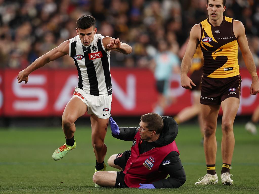 The Collingwood doctor slips and cleans up Nick Daicos as he arrives to check out his wellbeing. Picture: Michael Klein.