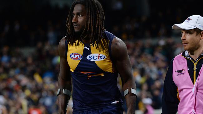 Nic Naitanui heads off Subiaco oval on crutches after tearing his ACL. Picture: Daniel Wilkins