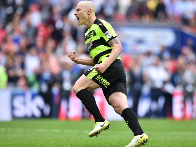 Huddersfield Town's Australian midfielder Aaron Mooy celebrates scoring his penalty.