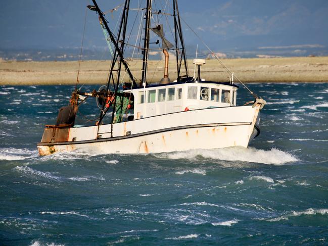 "Small fishing trawler in rough seas, New Zealand"