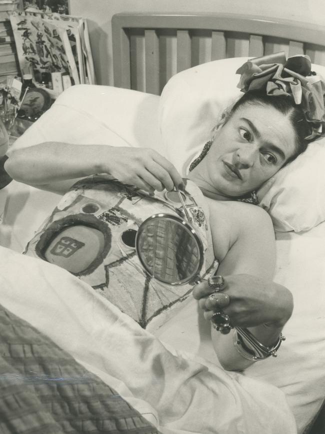 Frida at ABC Hospital holding a mirror, Mexico, 1950.