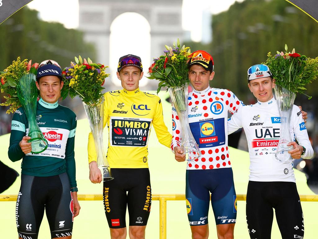 Jasper Philipsen wears the best sprinter's green jersey, Jonas Vingegaard wears the overall leader’s yellow jersey, Giulio Ciccone wears the best climber‘s polka dot jersey, and Tadej Pogacar wears the best young rider's white jersey at the conclusion of the 2023 Tour de France. Picture: Etienne Garnier/POOL/AFP