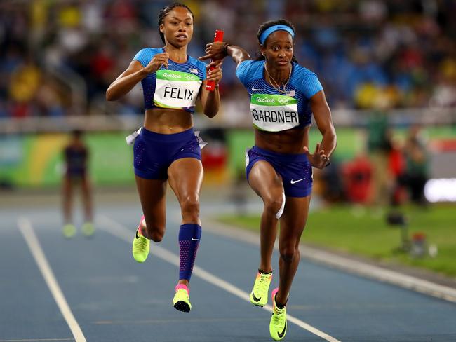 United States' Allyson Felix, left, hands off safely to English Gardner in their relay re-run.