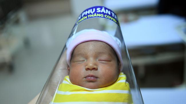 A newborn baby wearing a face shield at the National Maternity Hospital in Hanoi, Vietnam. Picture: AFP