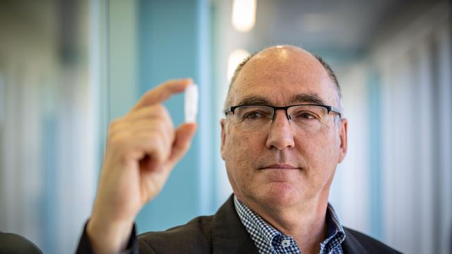 CSL chief scientific officer Andrew Nash holds up a vial of material used to make the vaccine. Picture: Getty Images