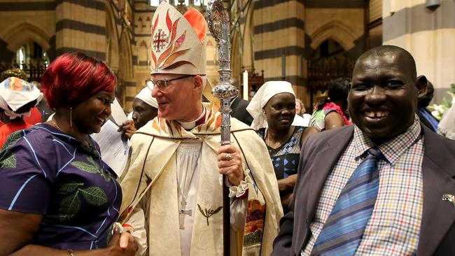 Anglican Archbishop Philip Freier meets with members of the African community at St Paul's church in Melbourne. Picture: Stuart McEvoy.