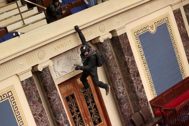 WASHINGTON, DC: A protester is seen hanging from the balcony in the Senate Chamber. Picture: Win McNamee/Getty Images/AFP