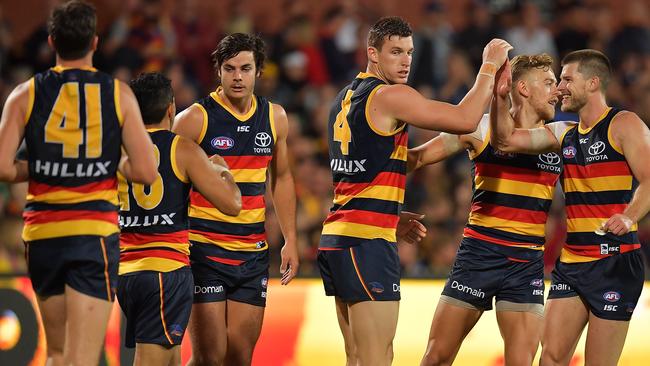 Adelaide players celebrate a goal during Thursday night’s big win against Richmond. Picture: Daniel Kalisz (Getty Images).