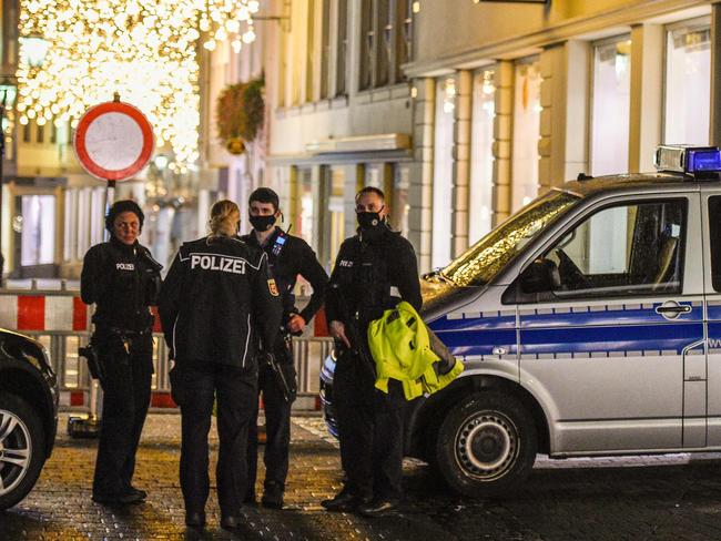 Police stand near Christmas illuminations as they secure a street near one of  the scenes where a car drove into pedestrians the center of Trier, southwestern Germany, on December 1, 2020. - At least two people were killed and several injured when a car drove into a pedestrian zone in the southwestern German city of Trier on December 1, 2020, police said, adding that the driver had been arrested. (Photo by JEAN-CHRISTOPHE VERHAEGEN / AFP)