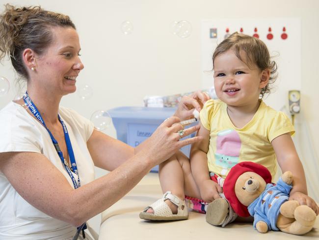 Royal Children’s Hospital nurse practitioner Sonja Elia gives Mackenzie, 17 months, a vaccination injection. Picture: Jason Edwards