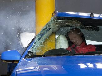 Photo of a Ford Falcon undergoing a pole crash test. The side airbag, which deploys from the seat, protects the driver's head and torso.