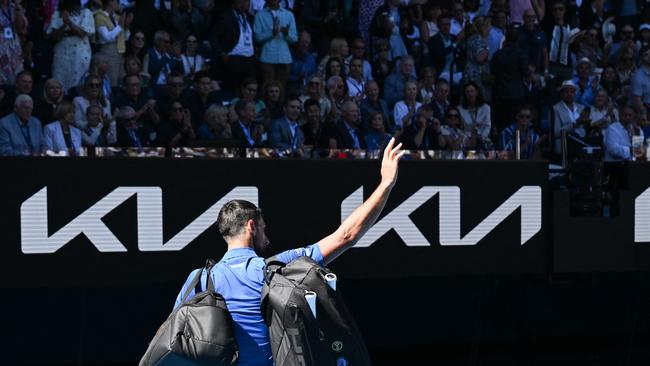 Serbia's Novak Djokovic acknowledges the applause as he exits the court after retiring from the men's singles semifinal against Germany's Alexander Zverev on day thirteen of the Australian Open tennis tournament in Melbourne on January 24, 2025. (Photo by WILLIAM WEST / AFP) / -- IMAGE RESTRICTED TO EDITORIAL USE - STRICTLY NO COMMERCIAL USE --