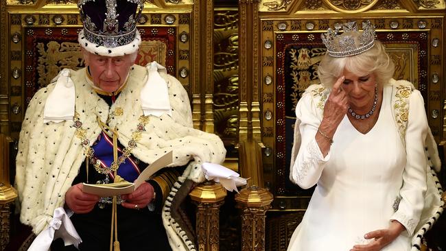 King Charles III, wearing the Imperial State Crown and the Robe of State, sits alongside Britain's Queen Camilla, wearing the George IV State Diadem, as he reads the King's Speech from the Sovereign's Throne in the House of Lords chamber, during the State Opening of Parliament, at the Houses of Parliament, on July 17, 2024 in London, England. King Charles III delivers the King's Speech setting out the new Labour government's policies and proposed legislation for the coming parliamentary session. (Photo by Henry Nicholls – WPA Pool/Getty Images)