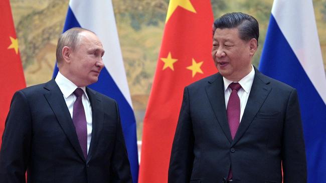 Russian President Vladimir Putin (L) and Chinese President Xi Jinping pose for a photograph during their meeting in Beijing, on February 4.