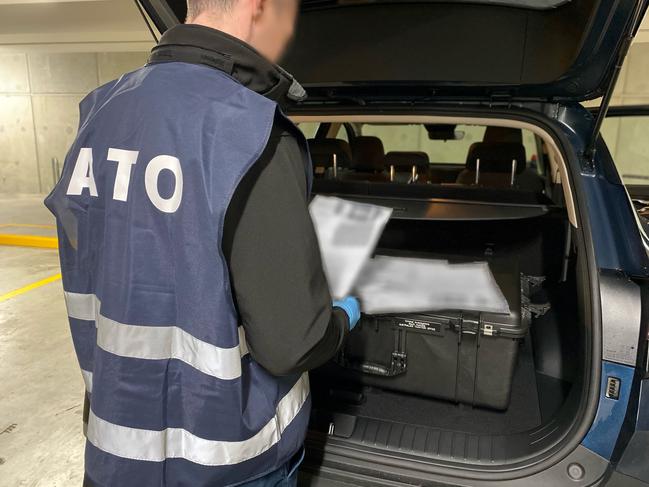 Australian Taxation Office investigators conducting raids on six individuals in Adelaide in connection with the Operation Protego GST refund scam. Pics - ATO