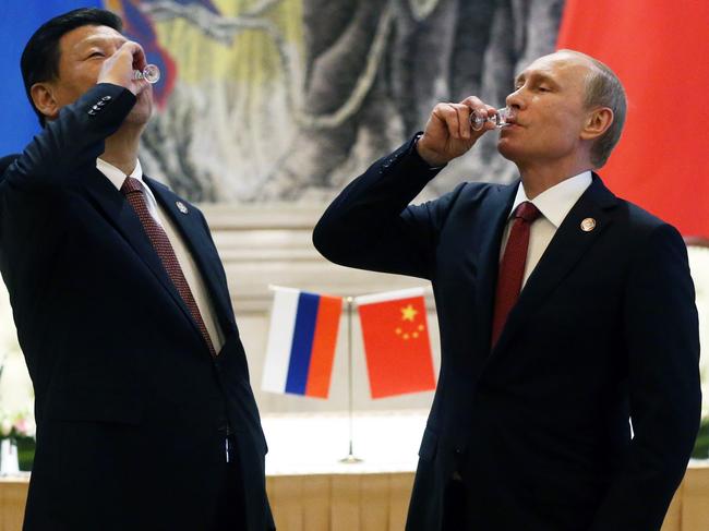 SHANGHAI, CHINA - MAY 21: President of Russia Vladimir Putin and Chinese President Xi Jinping toast with vodka during a signing ceremony on May 21, 2014 in Shanghai, China. Russia and China signed a thirty-year contract for supply of gas. (Photo by Sasha Mordovets/Getty Images)