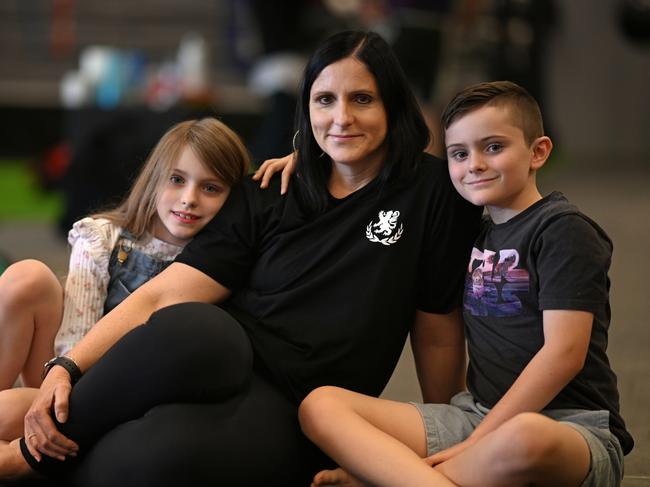 EMBARGO FOR TWAM 03 FEB 2024. FEE MAY APPLY.11/07/2023:  Lisa George, 47 (and with 2 of her 5 children, Fionnuala 7 and Patrick 9), at her martial arts business, in Petrie, northern Brisbane. Lisa suffered with chronic UTI for over 20 years and was diagnosed and started antibiotic treatment in 2018. Lyndon Mechielsen/TWAM